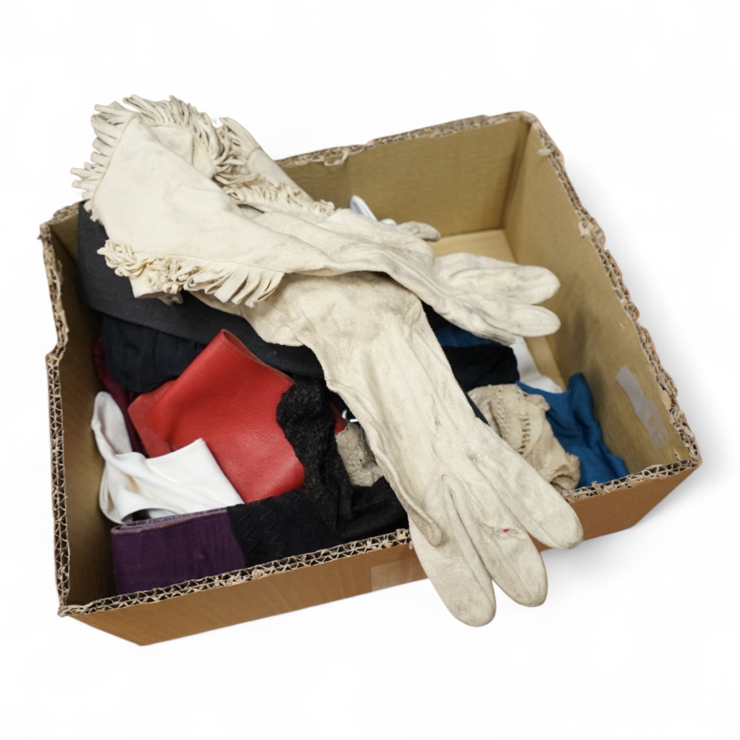 A collection of ladies early 20th century coloured silk stockings, leather and suede belts, a pair of cream leather gauntlets and various gloves